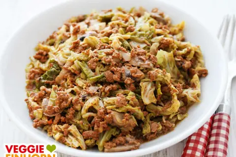 Herzhafte wirsingpfanne vegetarisch mit Pilzen und Hack-Alternative, serviert in einer weißen Schüssel.