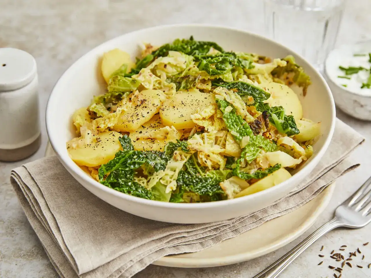 Herzhafte wirsingpfanne vegetarisch mit Kartoffeln, gewürzt mit Pfeffer und Kümmel. Ein einfaches, aber köstliches Gericht.